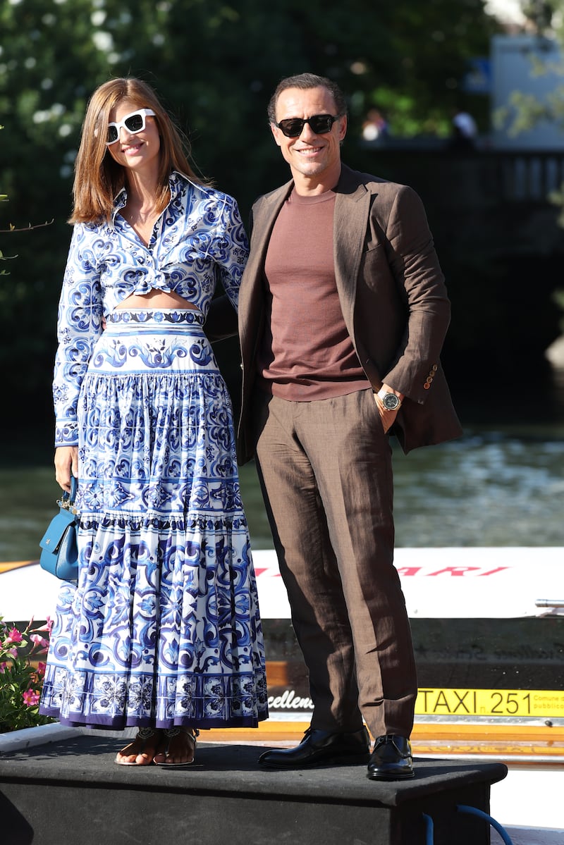 Looking relaxed, Bianca Vitali wears Dolce & Gabbana, and Stefano Accorsi a simple chocolate brown suit, with a crew-neck top. Getty