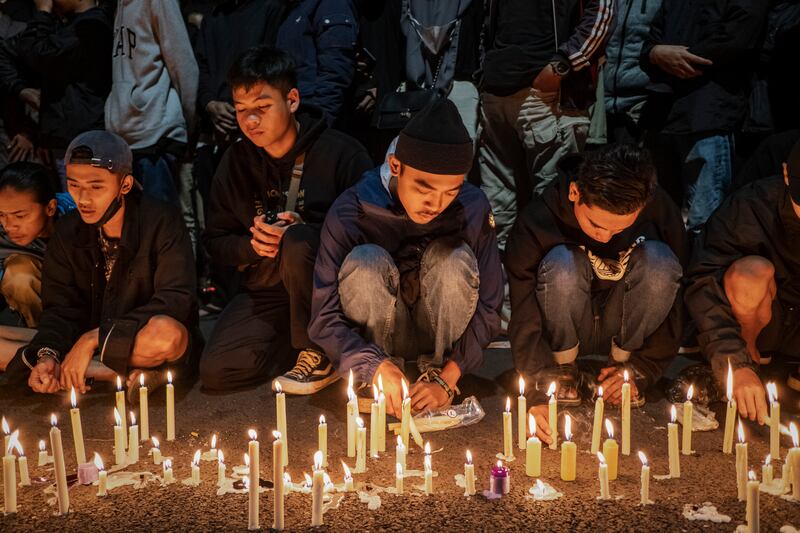 Arema football club supporters light candles as they pray for the victims in Malang, Indonesia. Getty Images