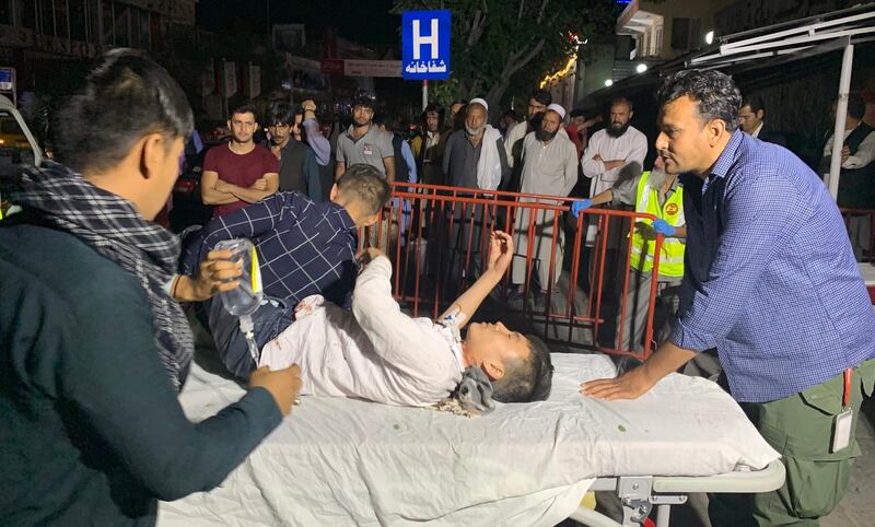 Afghan health workers carry a wounded child into the hospital after a suicide attacker exploded his explosive vest among a wedding ceremony in a wedding hall in Kabul. EPA