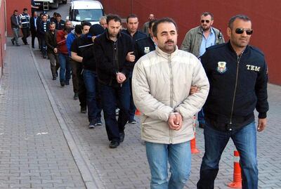 Turkish police escort suspects of the Gulen movement in the Turkish city of Kayseri in 2017, months after a failed coup attempt. EPA