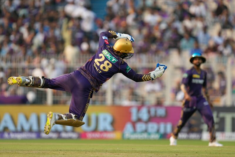 Kolkata Knight Riders' Phil Salt dives to catch Lucknow Super Giants' Marcus Stoinis out. AP