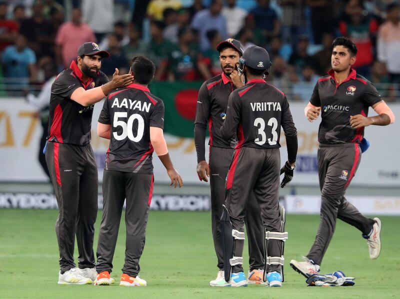 UAE bowler Aayan Afzal Khan celebrates after taking the wicket of Bangladesh's Litton Das for 25.