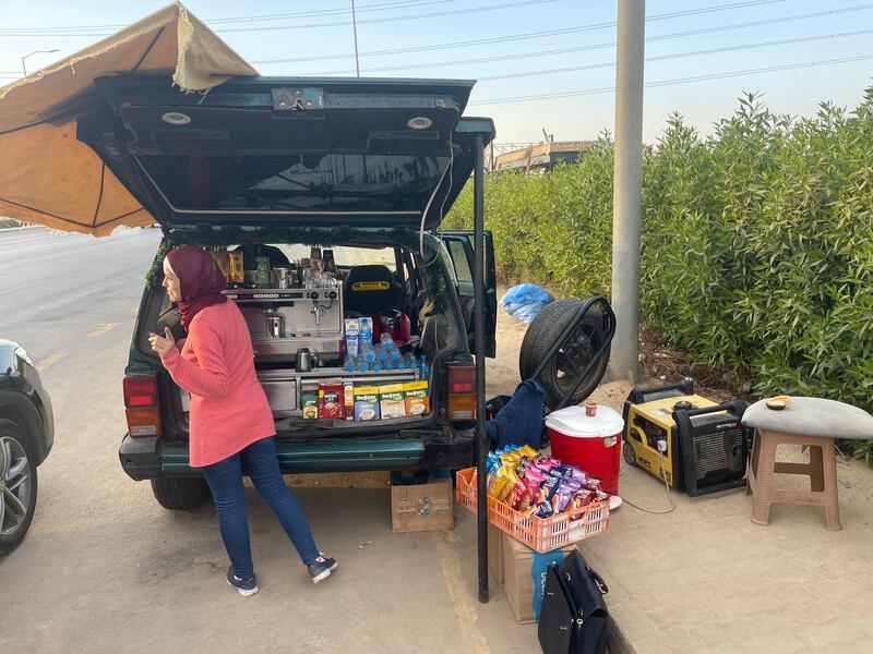 A coffee vendor serving a customer on a Cairo highway. Kamal Tabikha / The National