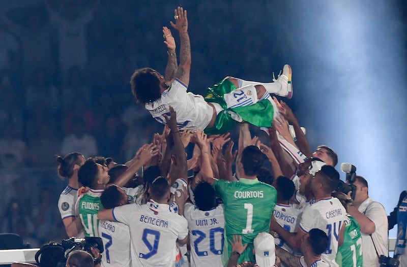 Marcelo is tossed in the air by teammates during the club's celebration of their 14th European Cup at the Santiago Bernabeu. AFP