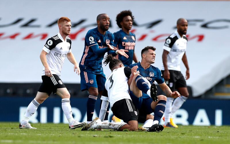 Arsenal's Granit Xhaka is tackled by Michael Hector of Fulham. PA