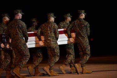 Military personnel carry a transfer case for Sgt Diego Pongo, one of two US Marines killed during a raid on an ISIS complex in Iraq on March 8, 2020. Getty Images / AFP