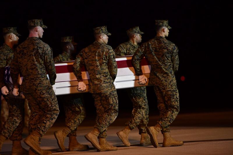 DOVER, DE - MARCH 11: Military personnel carry a transfer case for fallen service member U.S. Marine Gunnery Sgt. Diego D. Pongo, 34, during a dignified transfer at Dover Air Force Base on March 11, 2020 in Dover, Delaware. Pongo and Capt. Moises A. Navas was killed Sunday during a raid on a ISIS complex in Iraq, as part of Operation Inherent Resolve, according to a Department of Defense release.   Mark Makela/Getty Images/AFP
== FOR NEWSPAPERS, INTERNET, TELCOS & TELEVISION USE ONLY ==
