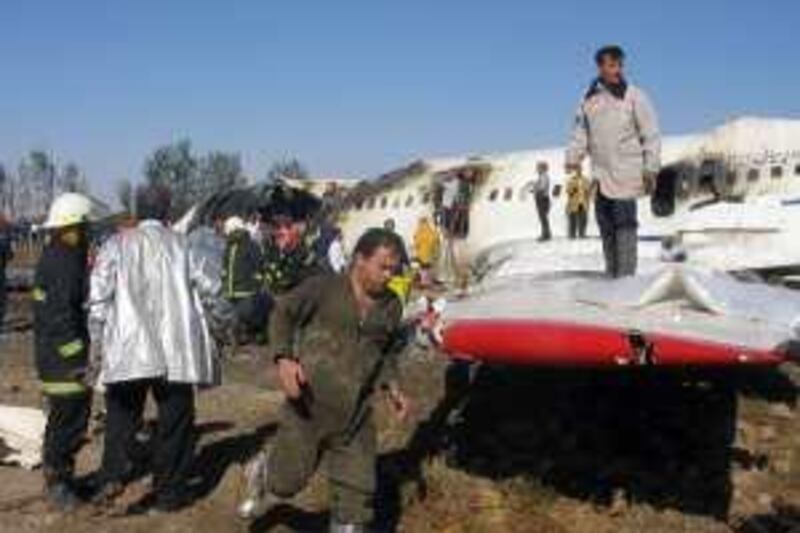 Emergency workers sift through the wreckage of the Tupolev 154 plane that crashed in Mashhad, 924 km (577 miles) east of Tehran, September 1, 2006. The Iranian airliner caught fire after a tyre burst on landing at a northeastern airport on Friday, killing at least 30 of the 148 people aboard, state television said. REUTERS/Stringer (IRAN)