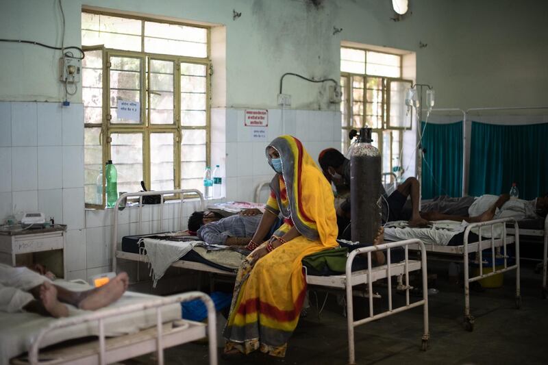 An Indian relative sits with a patient being treated for the coronavirus in the emergency ward at the BDM Government Hospital, which is currently treating 50 coronavirus cases across three wards designated for covid patients in Kotputli, Jaipur District, Rajasthan, India. Getty Images