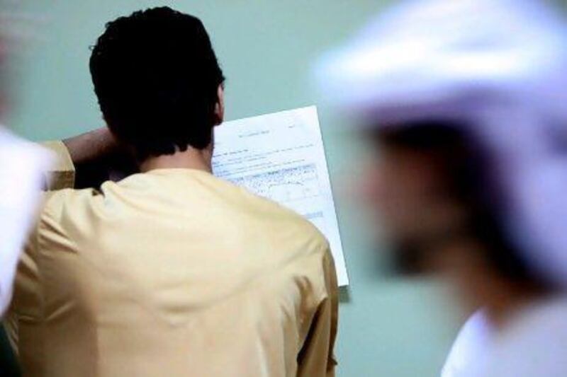 An Emirati student looks for a job at a job fair in Dubai. Paulo Vecina / The National
