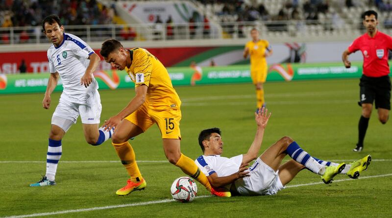 Chris Ikonomidis, centre, of Australia in action. EPA