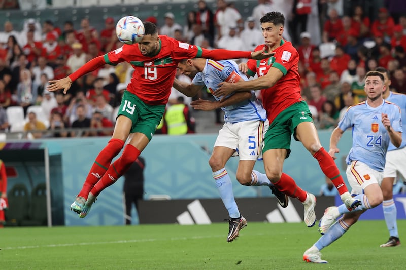 Youssef En-Nesyri, Sergio Busquets and Nayef Aguerd challenge for the ball. EPA 