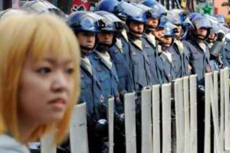 Japanese riot police stand behind their shields during a demonstartion by anti-G8 activists in Sapporo on July 5, 2008 ahead of the Hokkaido Toyako G8 Summit 2008. Police detained at least two activists as thousands of activists and farmers from around the world gathered in northern Japan for a major protest ahead of next week's summit of the Group of Eight rich nations.   AFP PHOTO/Kazuhiro NOGI *** Local Caption ***  834583-01-08.jpg