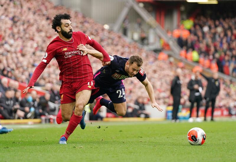 Liverpool's Mohamed Salah, left, challenges for the ball with Bournemouth's Ryan Fraser on Saturday. AP