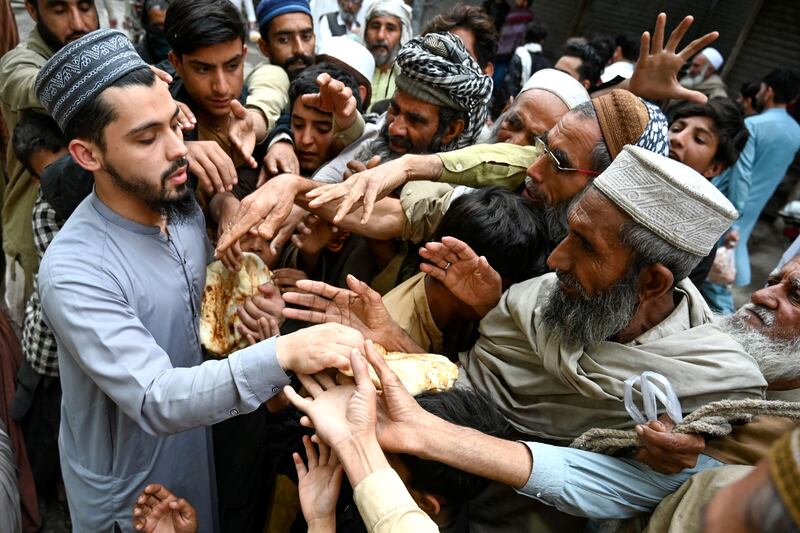 Men collect free bread during Ramadan in Peshawar, Pakistan. AFP