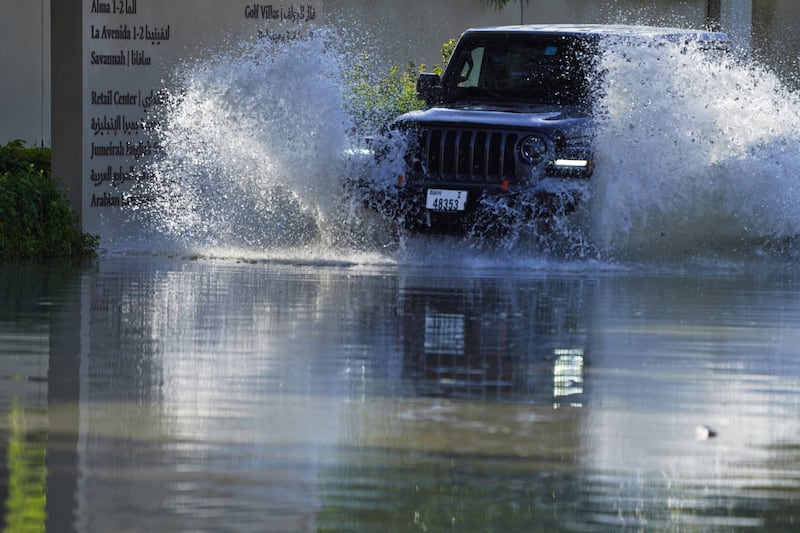 A car drives through floodwaters in Dubai. AP