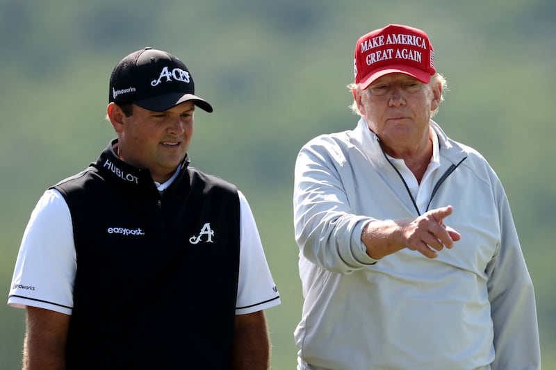 Mr Trump talks with golfer Patrick Reed during the pro-am prior to the LIV Golf Invitational. AFP