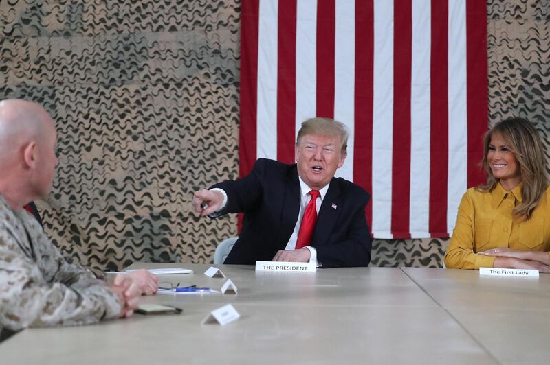 US President Donald Trump, travelling with first lady Melania Trump, meets with US political and military leaders during an unannounced visit to Al Asad Air Base, Iraq. Reuters