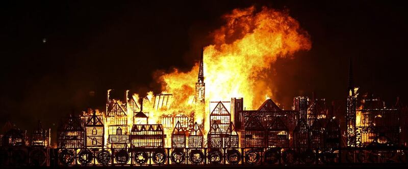 A replica of 17th-century London on a barge floating on the river Thames burns in an event to mark the 350th anniversary of the Great Fire of London, in London. AFP