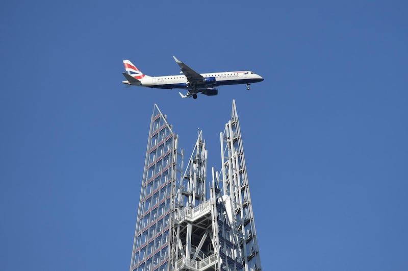 LONDON, ENGLAND - FEBRUARY 14: A British Airways plane makes it way towards City Airport, passing over the Shard building on February 14, 2019 in London, England.  (Photo by Leon Neal/Getty Images)