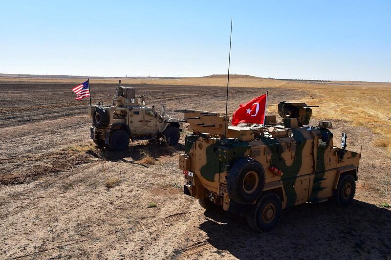 Turkish and U.S. military vehicles are seen on the Syrian-Turkish border during a joint U.S.-Turkey patrol near Tel Abyad, Syria, September 8, 2019.Turkish Defence Ministry/Handout via REUTERS ATTENTION EDITORS - THIS PICTURE WAS PROVIDED BY A THIRD PARTY. NO RESALES. NO ARCHIVE?