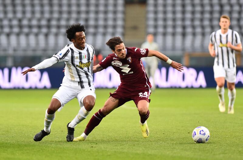 Torino's Simone Verdi in action with Juventus' Juan Cuadrado. Reuters