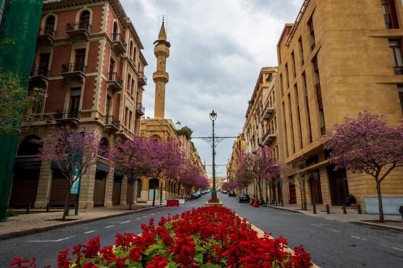 A security man sets along the empty Foch Street in Beirut, Lebanon, Saturday, April 3, 2021. Lebanese authorities imposed a three-day nationwide curfew as of Saturday morning to try limit the spread of COVID-19 during the Easter holidays. (AP Photo/Hassan Ammar)