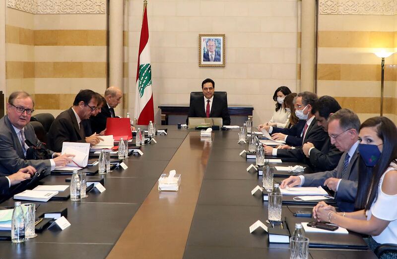 Prime Minister Hassan Diab chairs a meeting with French Foreign Minister Jean-Yves Le Drian. AFP