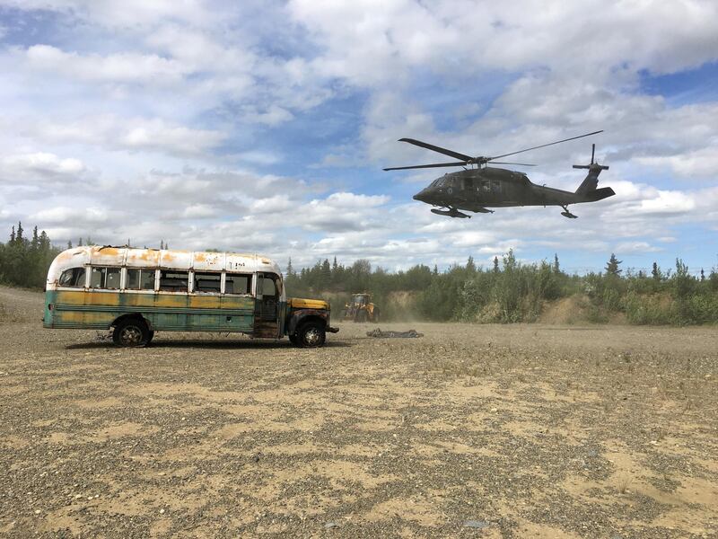FILE PHOTO: An Alaska Army National Guard UH 60 Blackhawk helicopter hovers near "Bus 142", made famous by the "Into the Wild" book and movie, after it was deposted by a CH-47 Chinook helicopter on the ground east of the Teklanika River alongside the Stampede Road, west of Healy, Alaska, U.S. June 18, 2020. Alaska Department of Natural Resources/Handout via REUTERS.  THIS IMAGE HAS BEEN SUPPLIED BY A THIRD PARTY./File Photo