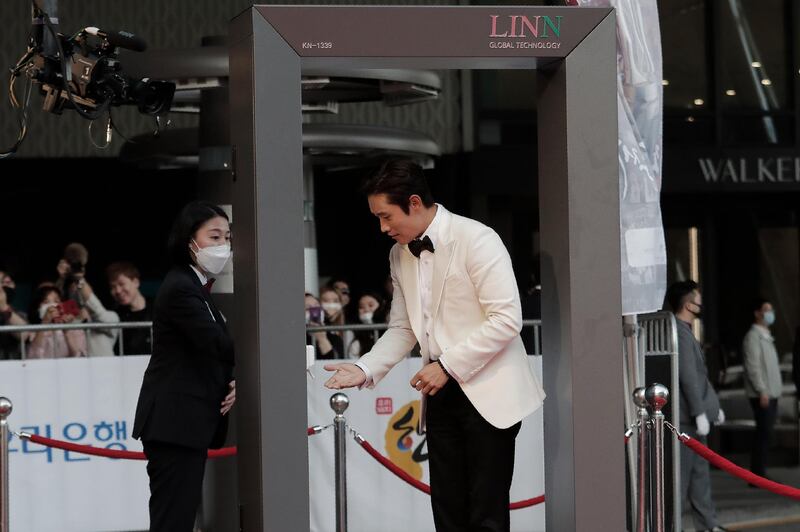 Lee Byung-hun receives hand sanitiser. AP