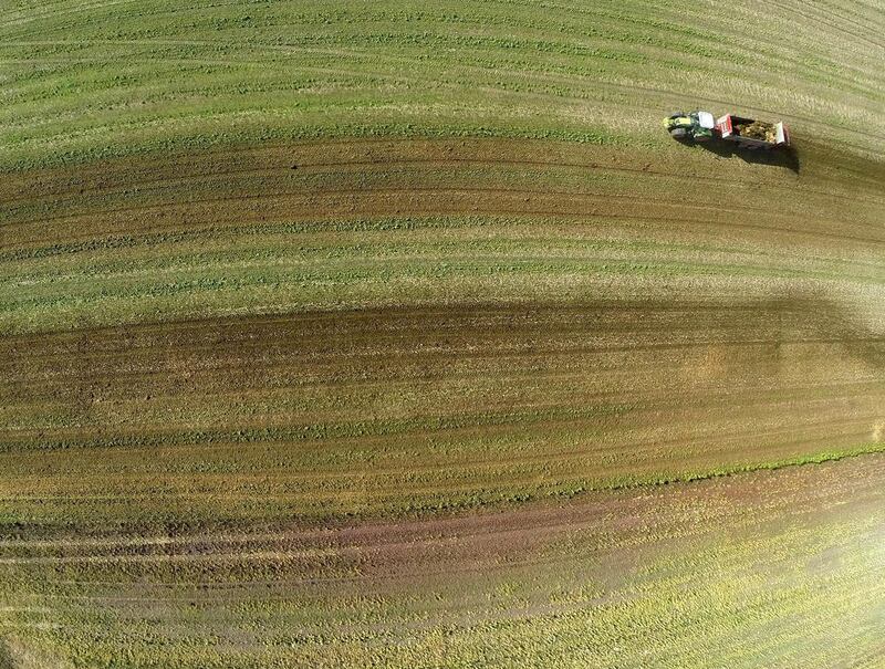 A GoPro camera mounted on a drone photographs a farmer as he fertilises a maize field in Orsoy, Germany in March 2014. Roland Weihrauch / EPA