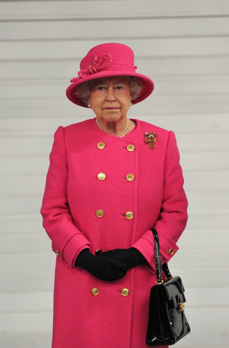 Queen Elizabeth II, wearing pink, pictured during a visit to the Bailey caravan factory as part of her diamond Jubilee tour on November 22, 2012, in Bristol, England. Getty Images