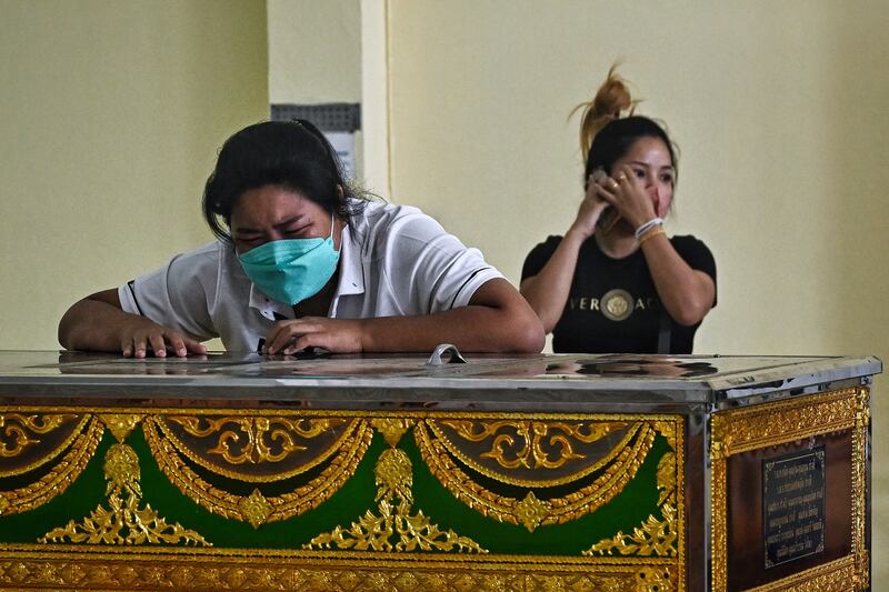 Relatives of a victim mourn at a temple on the Thai side of the border in Aranyaprathet. AFP