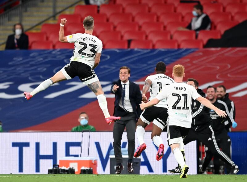 Fulham's Joe Bryan celebrates in front of manager Scott Parker after scoring his side's first goal in their Championship play-off final match win over Brentford at Wembley Stadium, in London, on Tuesday, August 4,. Getty