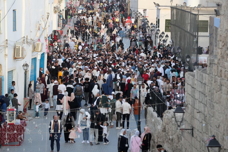 Libyans gather at the Bab al-Jadid gate in the old city of the capital Tripoli, as they celebrate the third day of Eid al-Fitr, which marks the end of the holy fasting month of Ramadan.  AFP