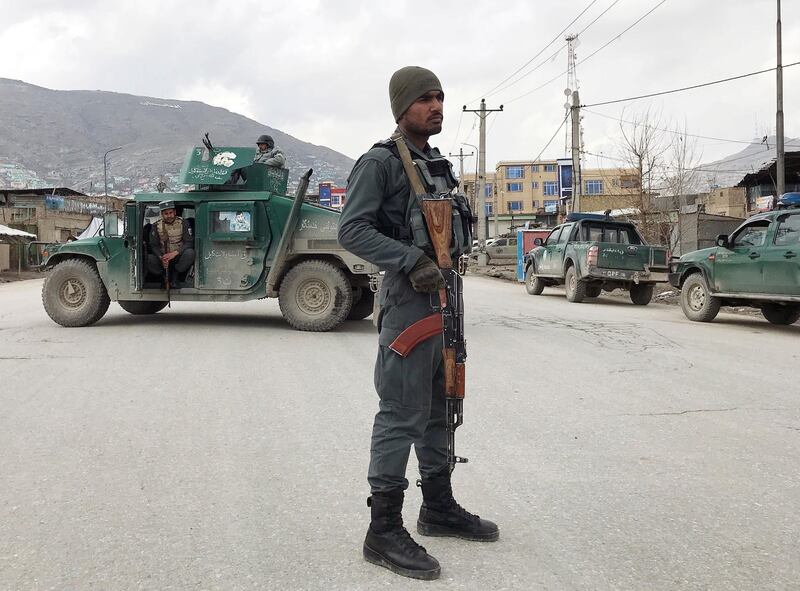 An Afghan policeman stands guard near the site of an attack in Kabul, Afghanistan. REUTERS