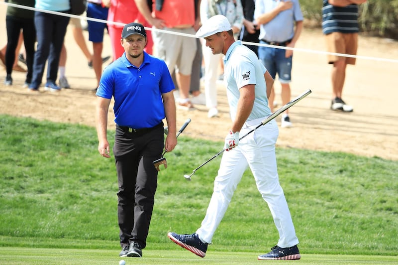 Eddie Pepperell of England and Bryson DeChambeau of the United States look on from the second hole. Getty