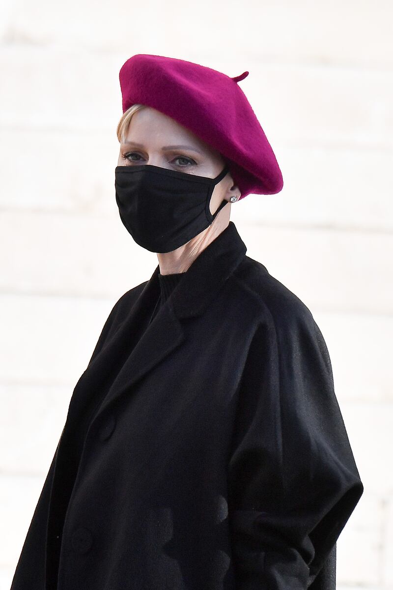 Princess Charlene, in a black coat and raspberry beret, attends the Sainte Devote Ceremony on January 27, 2021 in Monaco. Getty Images