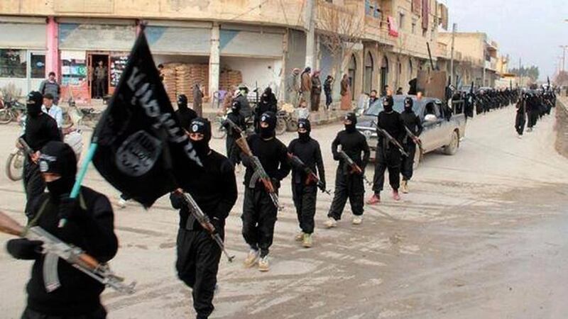 ISIL fighters marching in Raqqa, Syria. AP Photo

