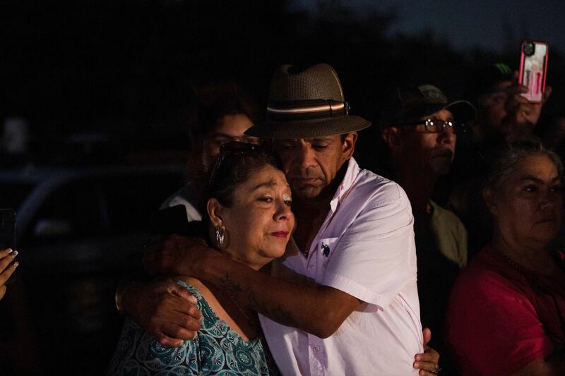 Christine and Michael Ybarra embrace at the scene where dozens of people were found dead inside a lorry in San Antonio, Texas. Reuters