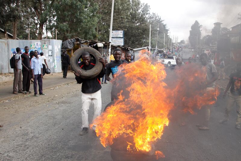 Supporters of Kenyan opposition leader and presidential candidate Raila Odinga demonstrate by blocking roads with burning tyres inthe Kibera slum in Nairobi, Kenya, Friday Aug. 11, 2017. Odinga says hackers infiltrated the database of the country's election commission and manipulated the results . Early results show President Uhuru Kenyatta with a wide lead over Odinga. (AP Photo/Khalil Senosi)