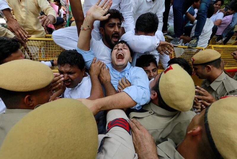 Supporters of India's main opposition party scuffle with police during a protest demanding the resignation of the country' minister of state for external affairs Mobashar Jawed Akbar in New Delhi. Reuters