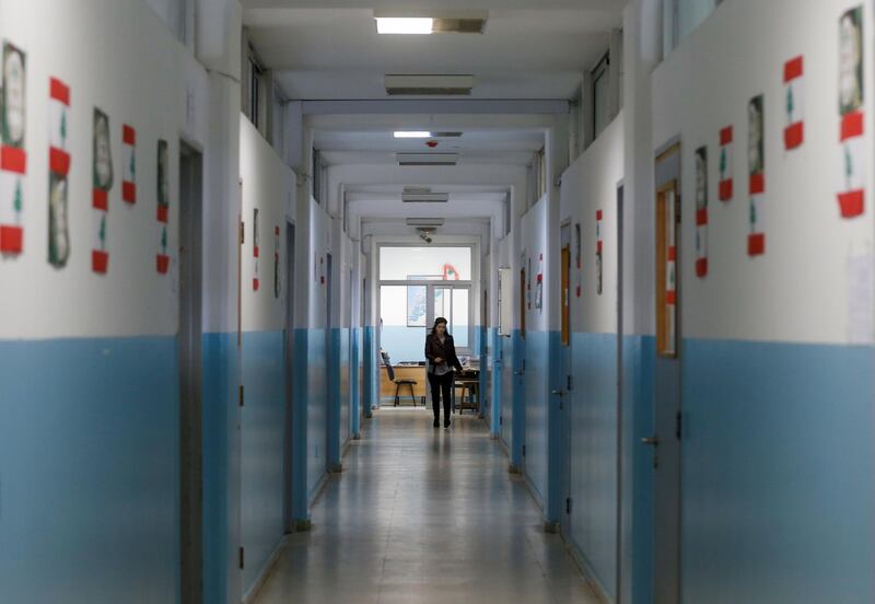 A teacher walks along a corridor of a public school in Beirut, Lebanon December 12, 2019. Reuters