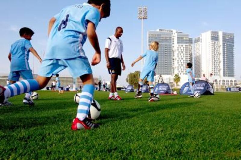 Manchester City's football development chief executive Patrick Vieira coaches a grouo of local children at Zayed Sports City in Abu Dhabi on February 15, 2012. Christopher Pike / The National