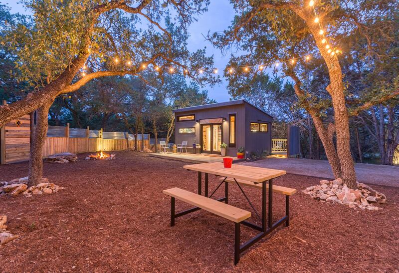 8. See the stars from this tiny home in Texas which has a hot tub perfect for two, a private yard, charcoal grill, picnic table, double hammock and twinkle lights hanging from the trees.