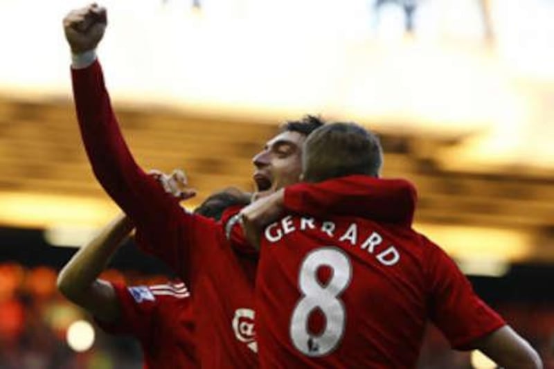 Liverpool's Albert Riera holds his arm aloft as he celebrates scoring the opener with Steven Gerrard.