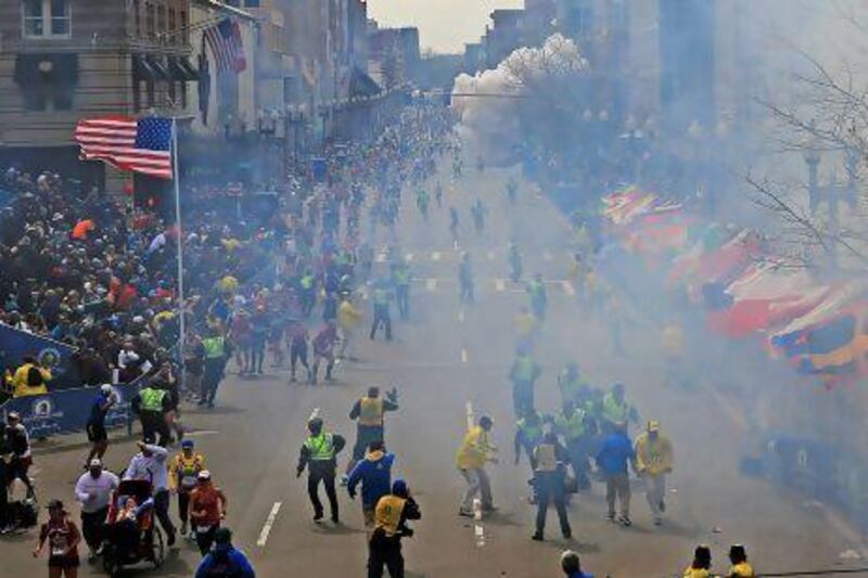 People run as an explosion goes off near the finish line of the 2013 Boston Marathon.