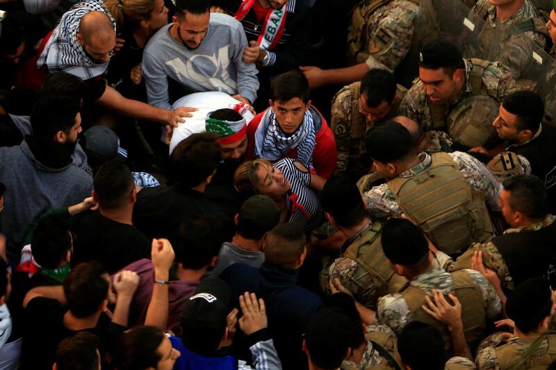 Lebanese army soldiers confront with demonstrators in an attempt to open a road blocked by them during ongoing anti-government protests in the port city of Sidon, Lebanon. Reuters