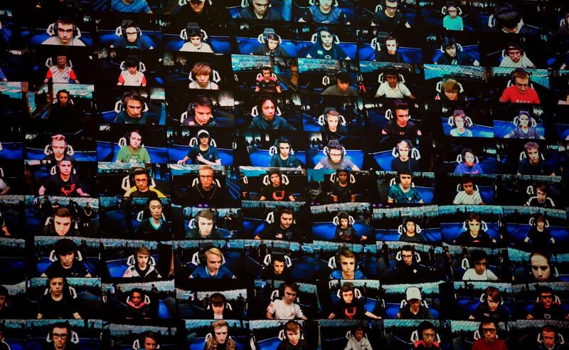 The players are seen on a TV screen during the final of the solo competition at the 2019 Fortnite World Cup inside of Arthur Ashe Stadium, in New York City.  AFP