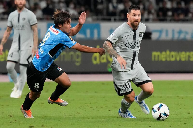 PSG attacker Lionel Messi under pressure from Kawasaki Flontale's Kento Tachibanada. AP